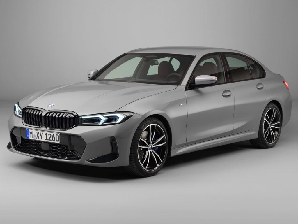 Silver BMW 3-series sedan in a front three-quarter view, showing its grille, blue headlights, and alloy wheels; license plate reads M XY 1260.