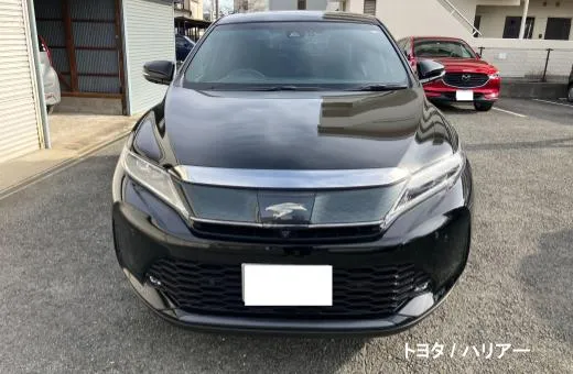 Front view of a black Toyota Harrier SUV parked, with the license plate blurred for privacy.